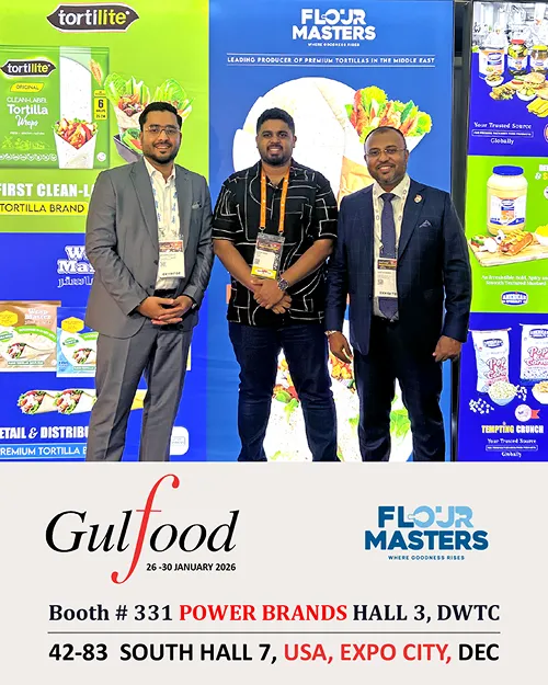 Three men in business attire posing at Flour Masters booth promoting Gulfood 2026 event details.