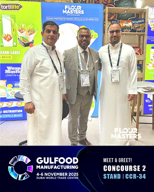 Three men posing at Flour Masters booth with Tortillite branding at Gulfood Manufacturing 2025 event.