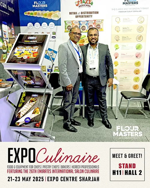 Two men in suits posing at Flour Masters booth during Expo Culinaire 2025 at Expo Centre Sharjah.