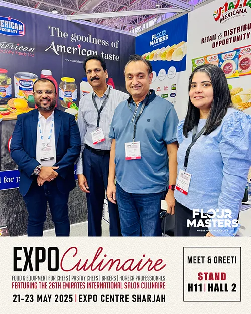 Four people with lanyards at a food expo booth promoting American Specialty Foods and Flour Masters.
