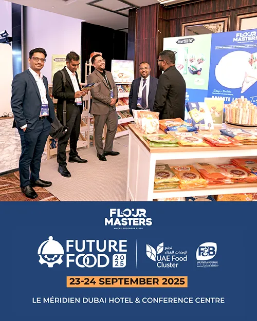 Five men in suits at a food event with products displayed and a sign for Future Food 2025 in Dubai.