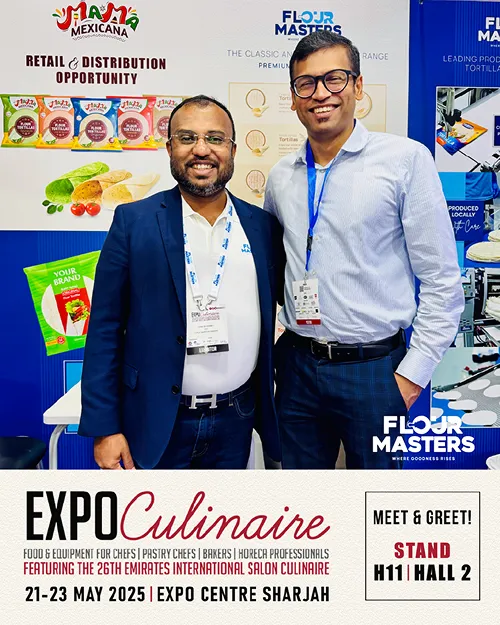 Two men smiling at a food expo booth with Flour Masters and Mama Mexicana branding in the background.
