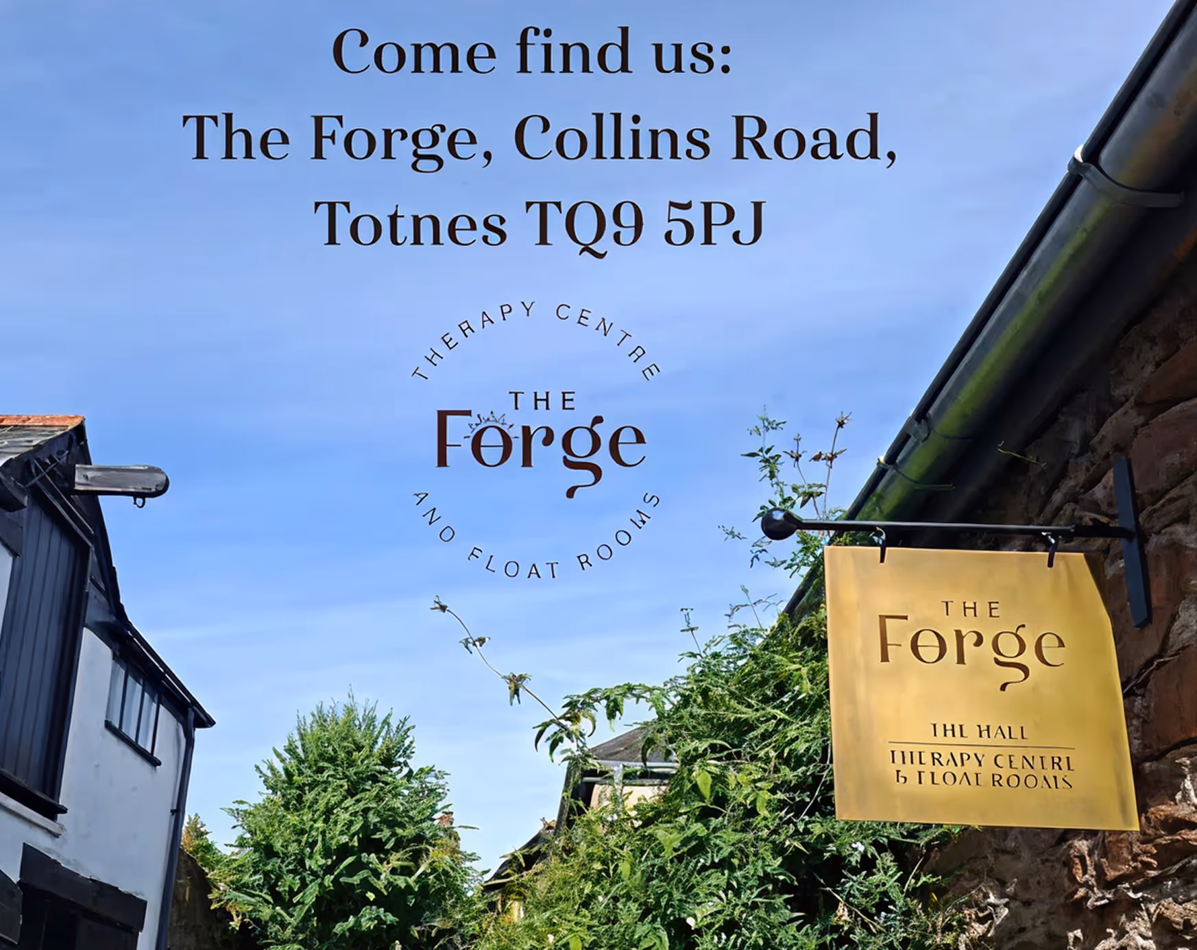 Sign for The Forge Therapy Centre and Float Rooms on a yellow board by a stone wall with greenery.