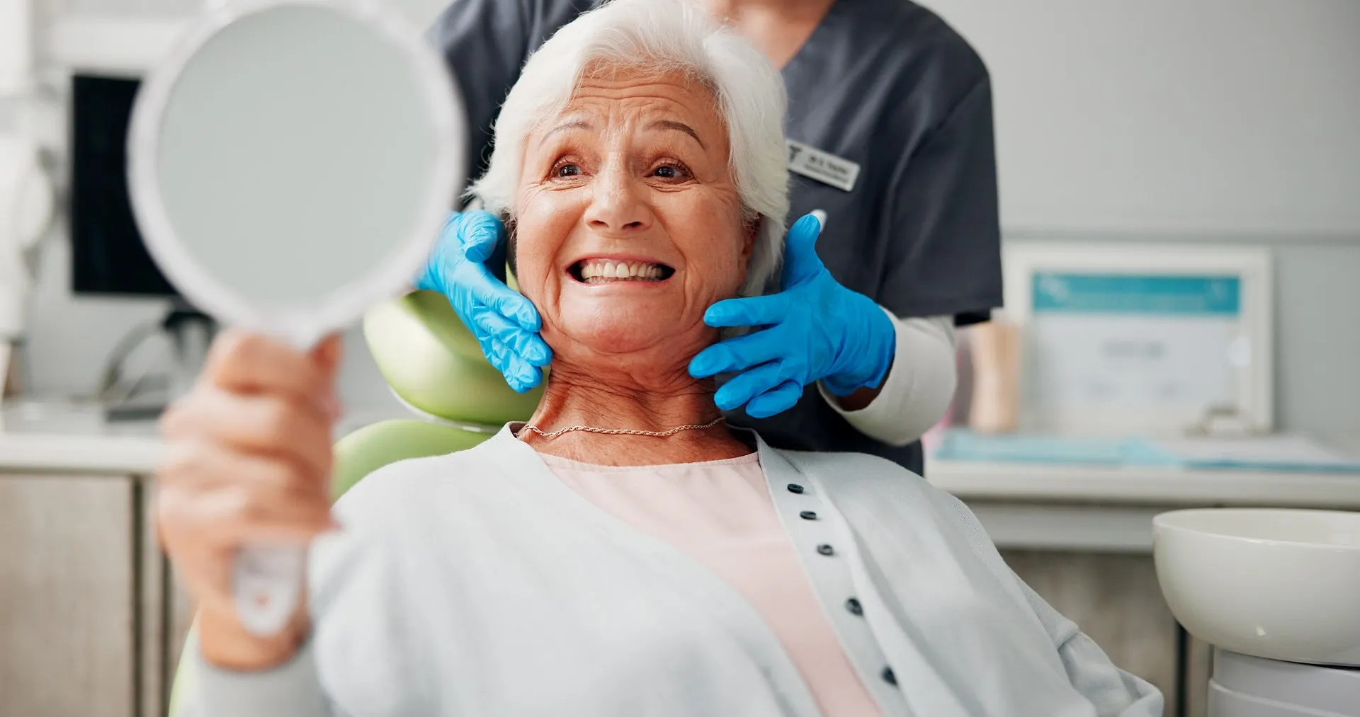 Patient smiling with a beautiful, natural-looking dental implant crown replacing a missing tooth