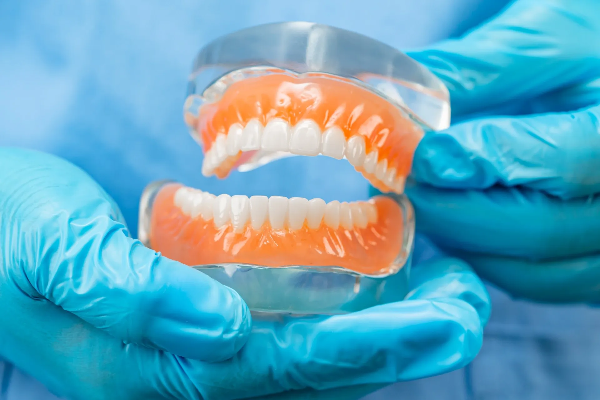 Dentist fitting a patient with a custom partial denture at Nova Dental Care of Chantilly