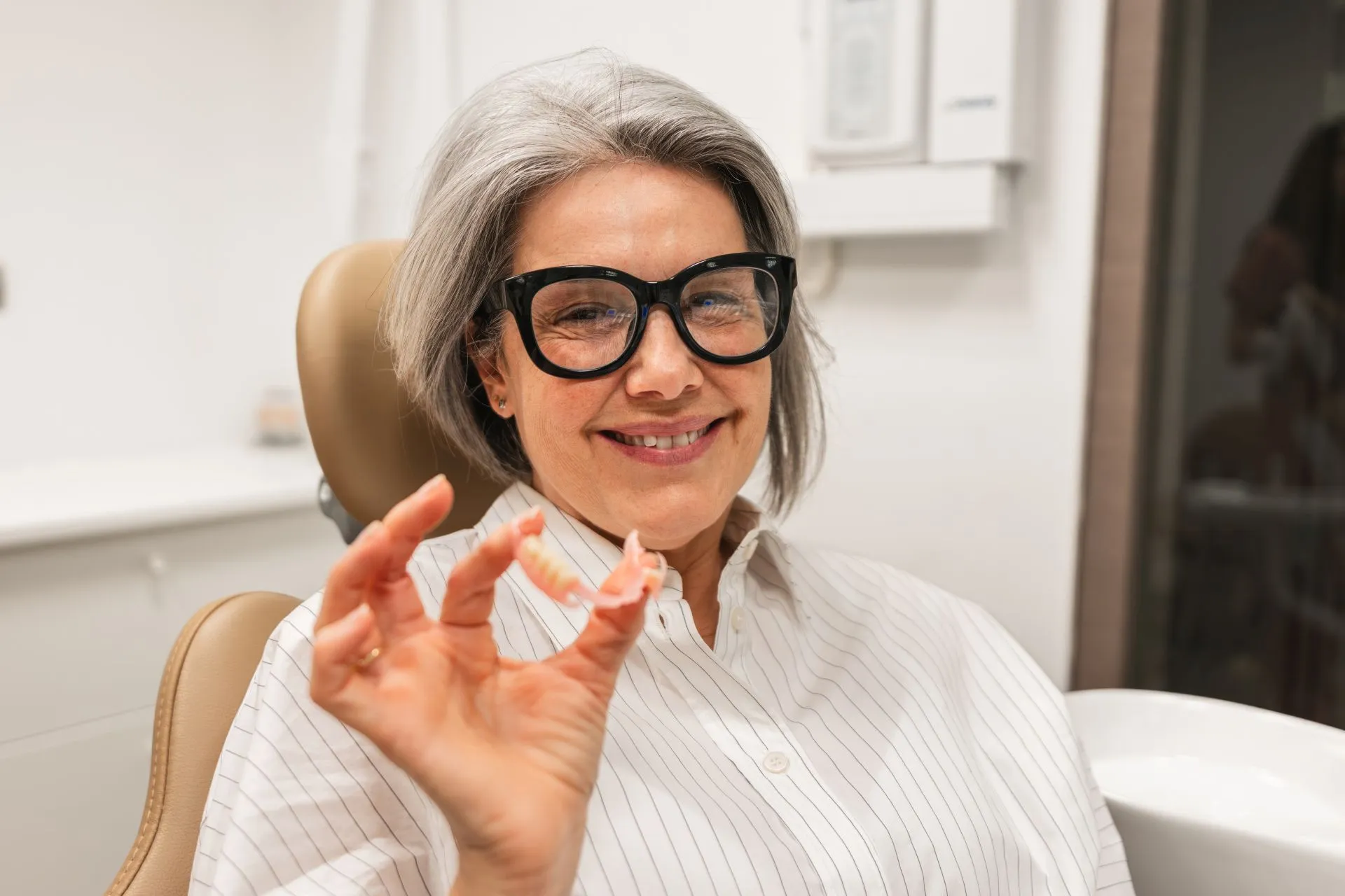 Dental professional providing in-home dental care to a senior patient in Chantilly, VA
