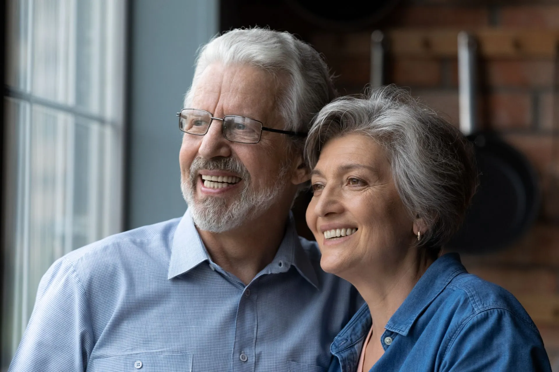 Patient smiling confidently after receiving permanent implant-supported teeth at Nova Dental Care of Chantilly