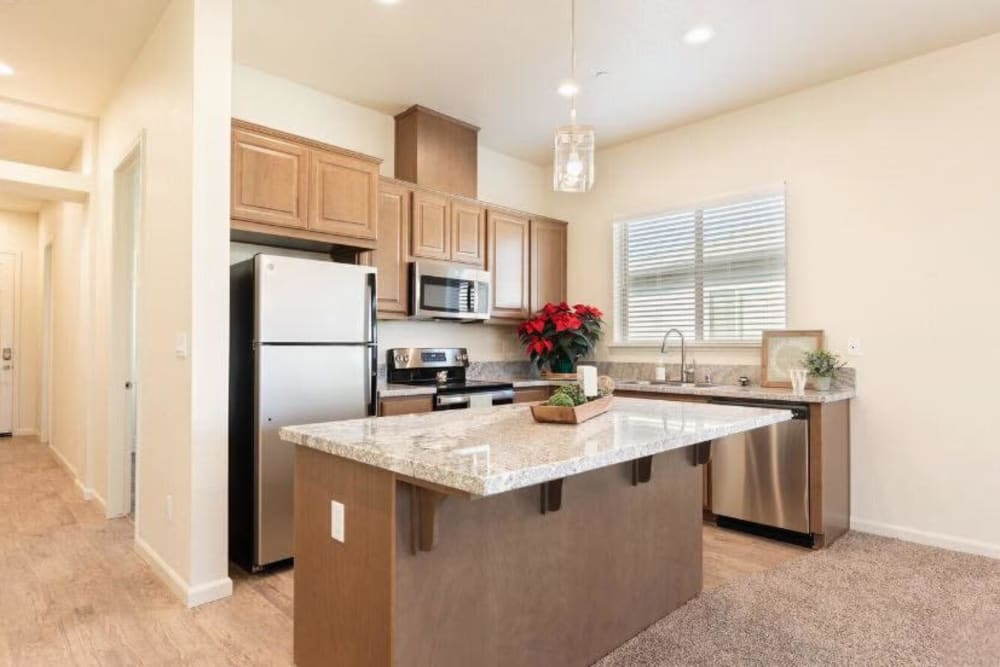 Kitchen with brown cabinets and steel appliances