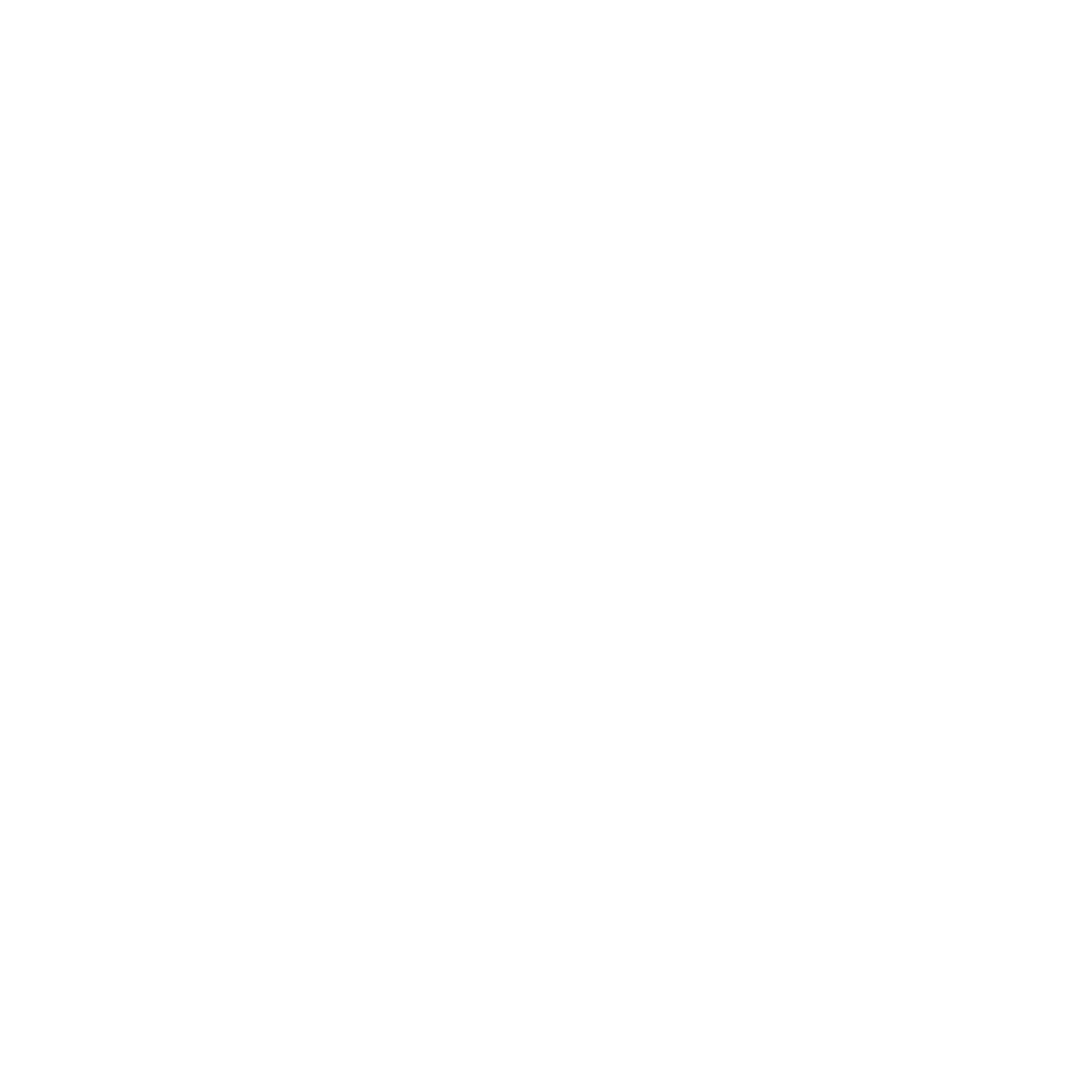 A cozy armchair with a small side table and a potted plant on a round rug with sparkles.