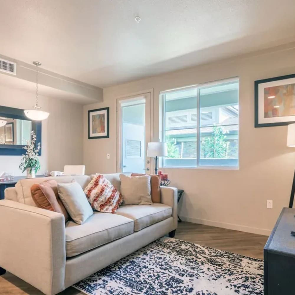 Living area with sofa and tv and large window