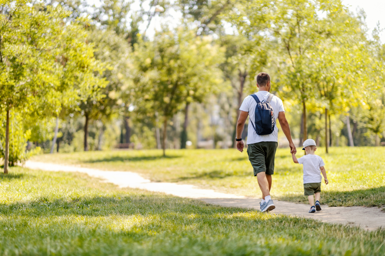 Adult with child walking outdoors stock image