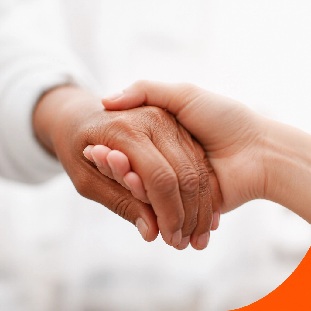 A close-up photograph of two hands clasped together, representing support and community.