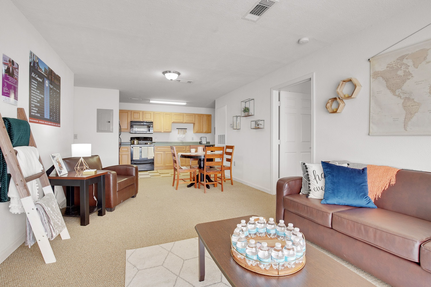 Wide view of living area with sofa and coffee table and view of dining and kitchen areas