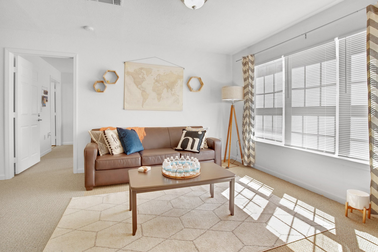 Living area with sofa, coffee table, and large window