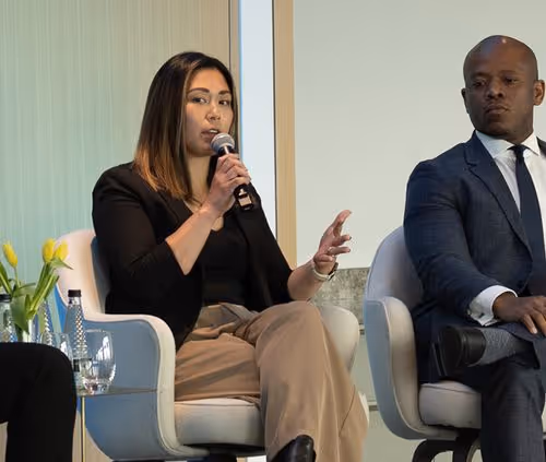 Christina Louie Dyer, Executive Director at Checkr.org speaking into a microphone during a panel discussion.