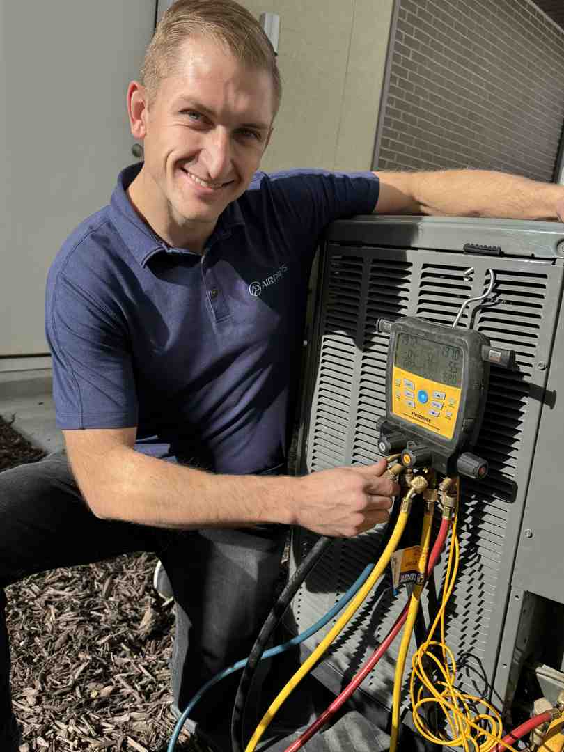 Air conditioner repair technician inspecting an outdoor unit in Salt Lake City - air conditioner repair salt lake city