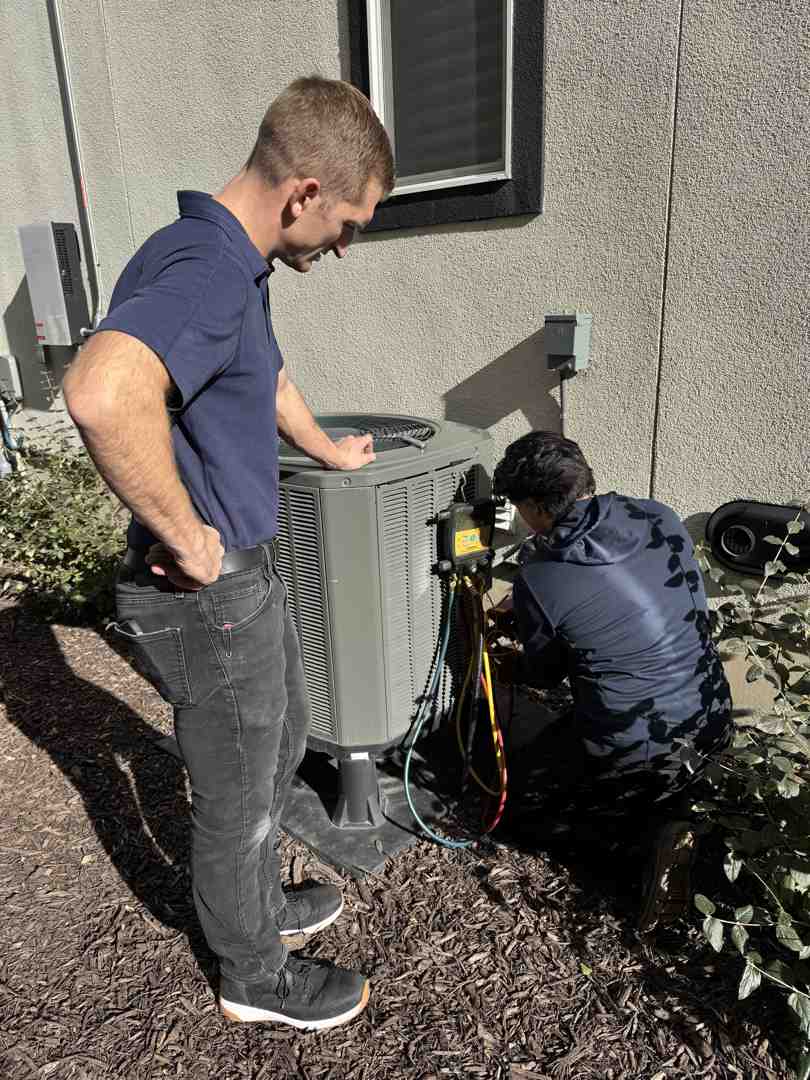 technician repairing air conditioner unit - ac repair herriman