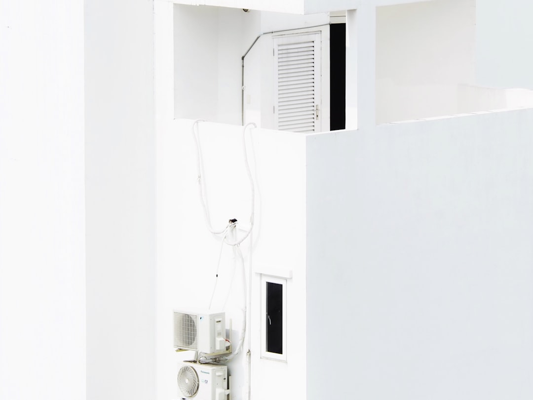 Sleek, wall-mounted ductless mini-split unit in a modern room, blending seamlessly with the decor - central air installation near me