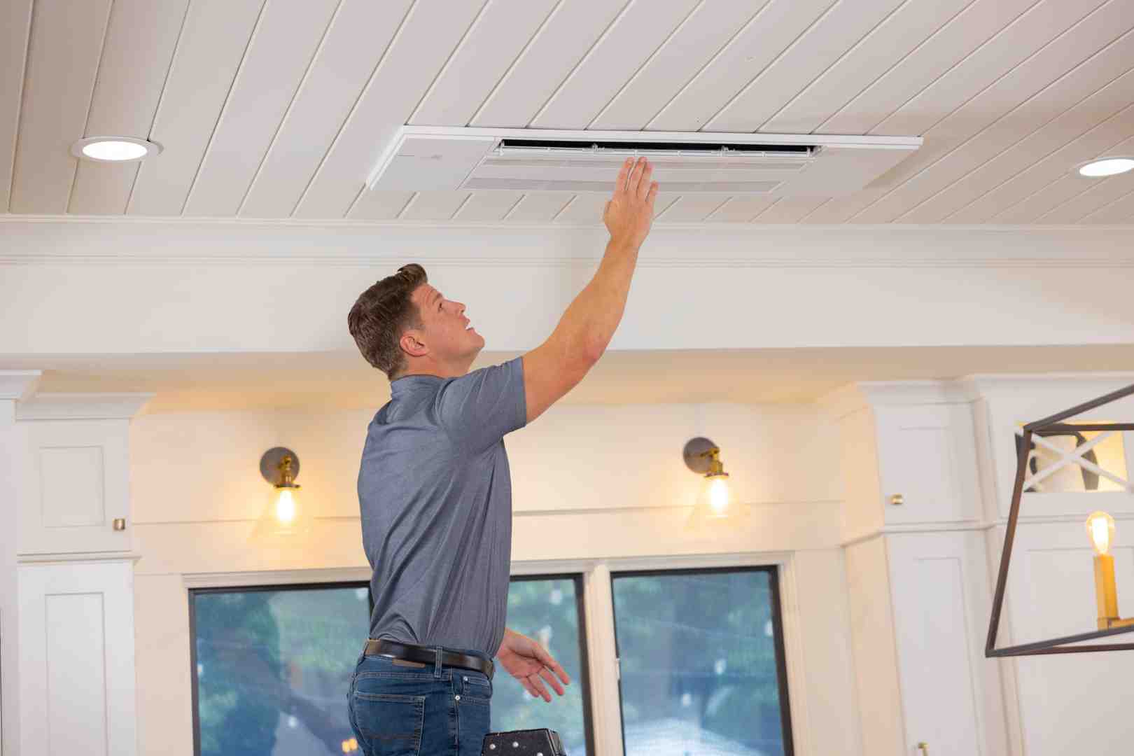 person cleaning mini split filter - Ductless mini split installation