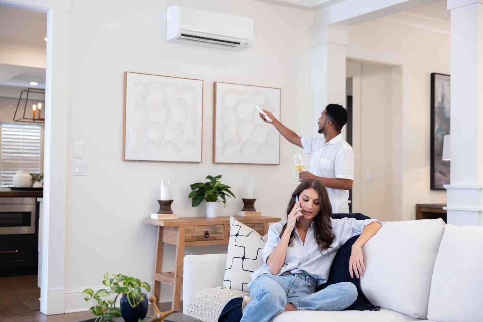 family enjoying comfortable living room with ductless mini split - Ductless mini split installation