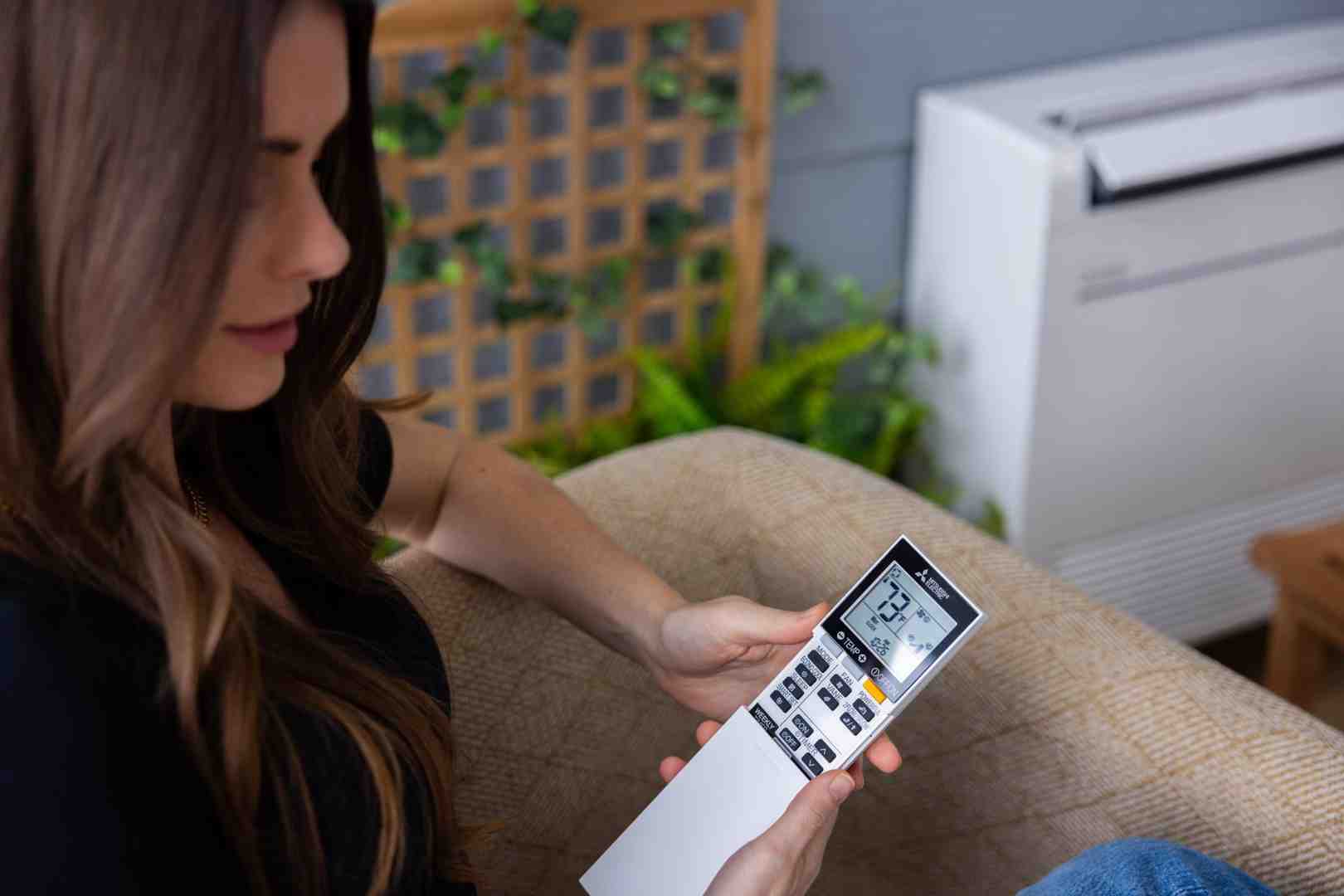 smartphone controlling mini split system through wi-fi app - ductless mini split systems