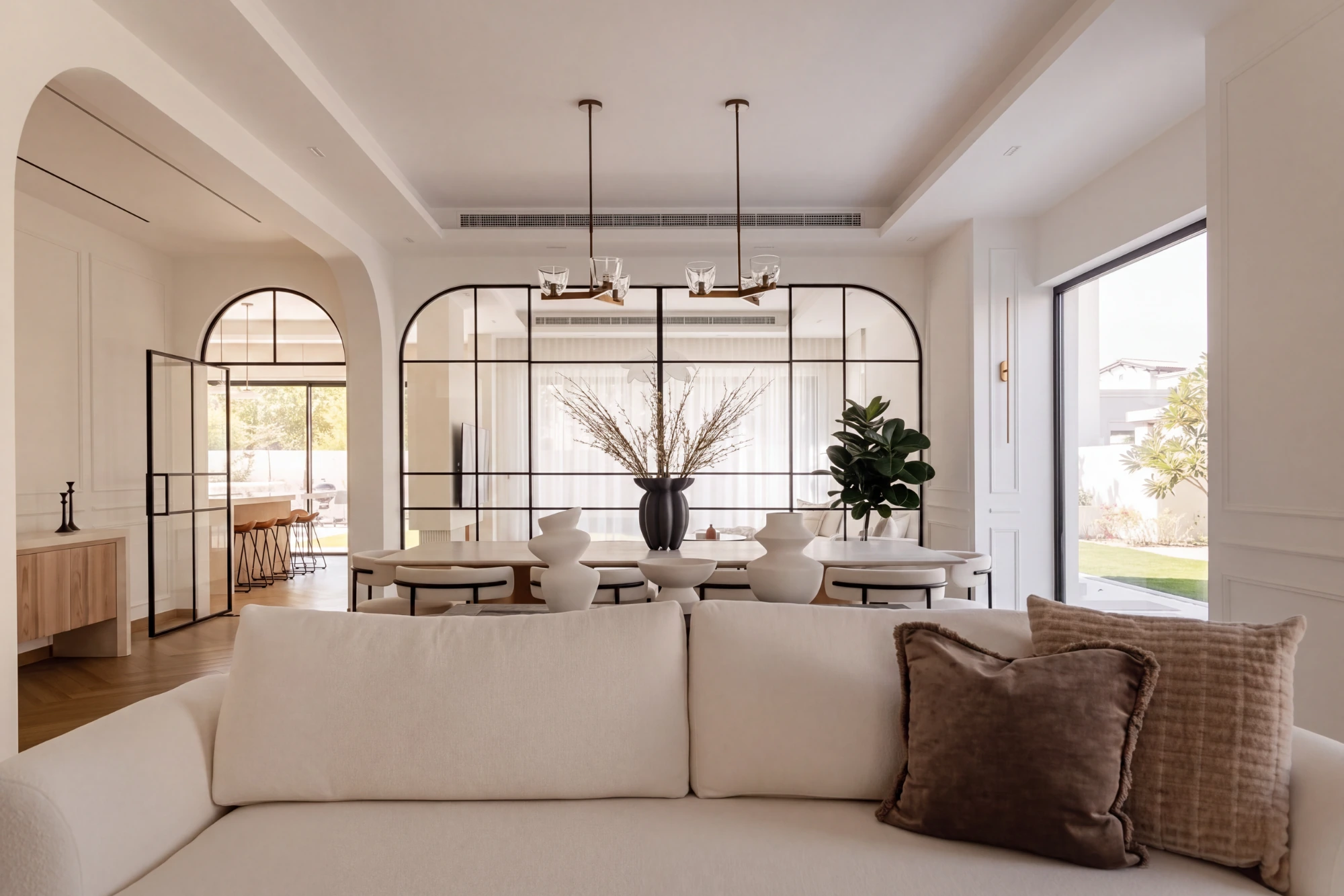 A remade principal floor in a renovated Dubai villa, finished reception in natural light