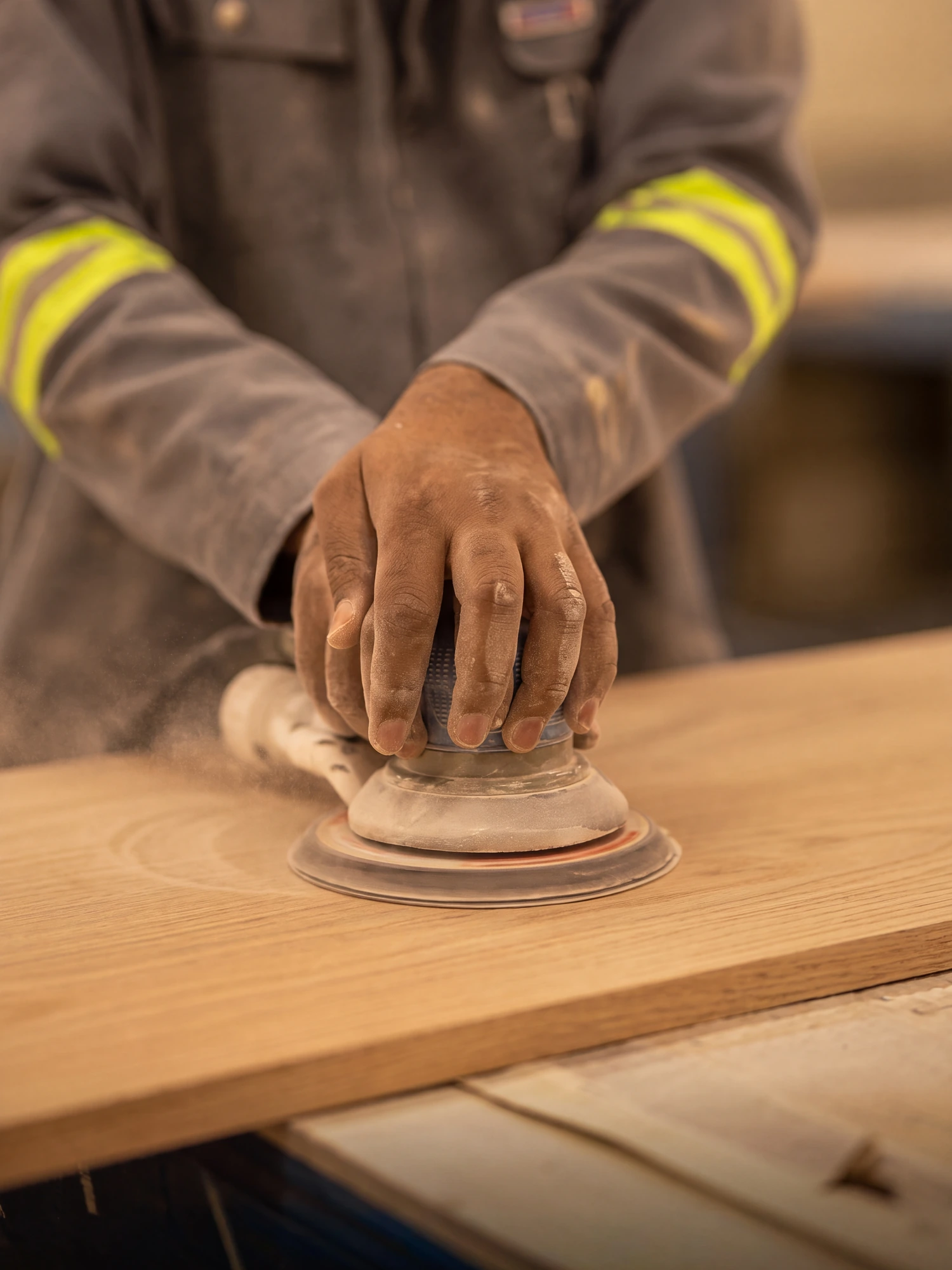 Faces of the panel being sanded by hand