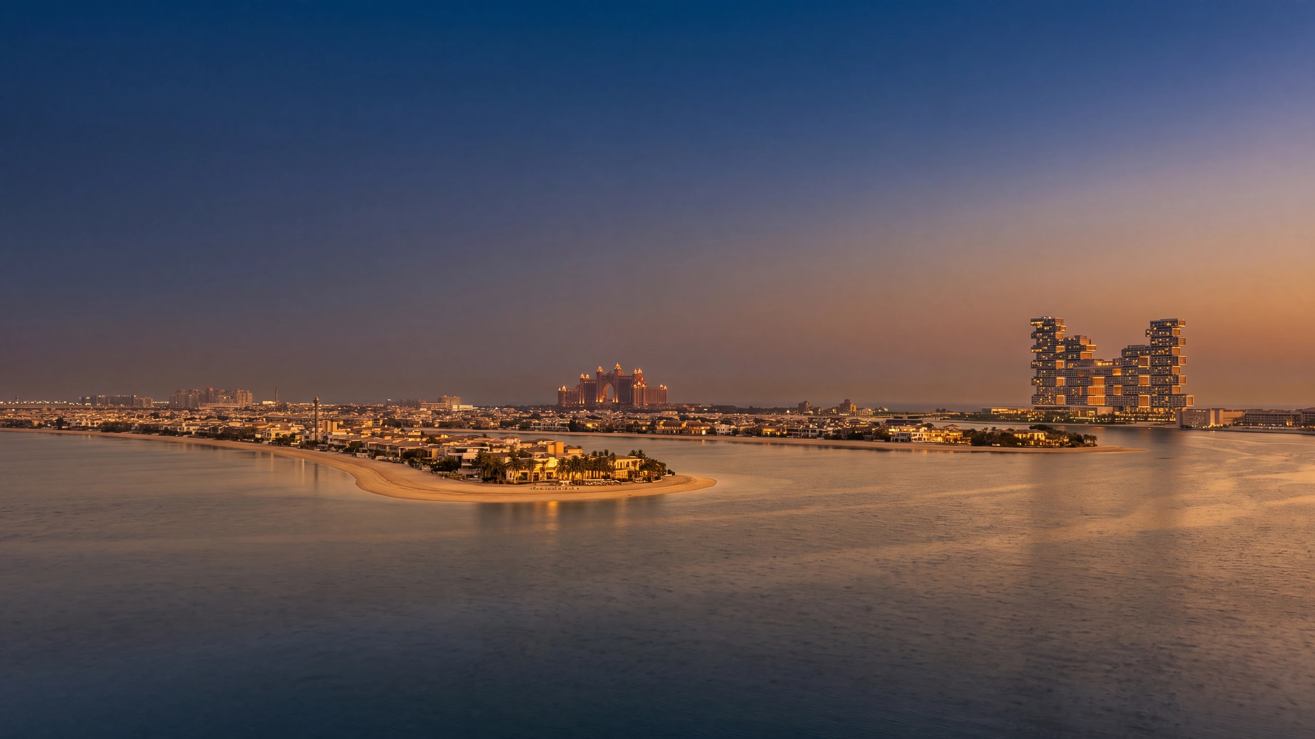 A villa on Palm Jumeirah at dusk, the frond and shoreline beyond