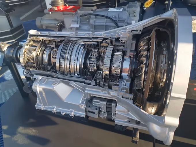 Cutaway view of an automotive transmission showing internal gears and components.