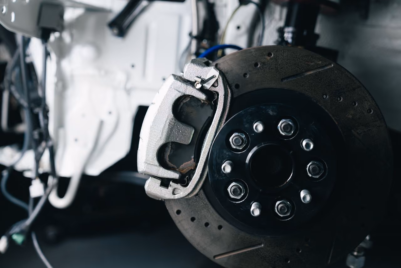 Close-up of a car brake disc and caliper assembly in a vehicle's braking system.