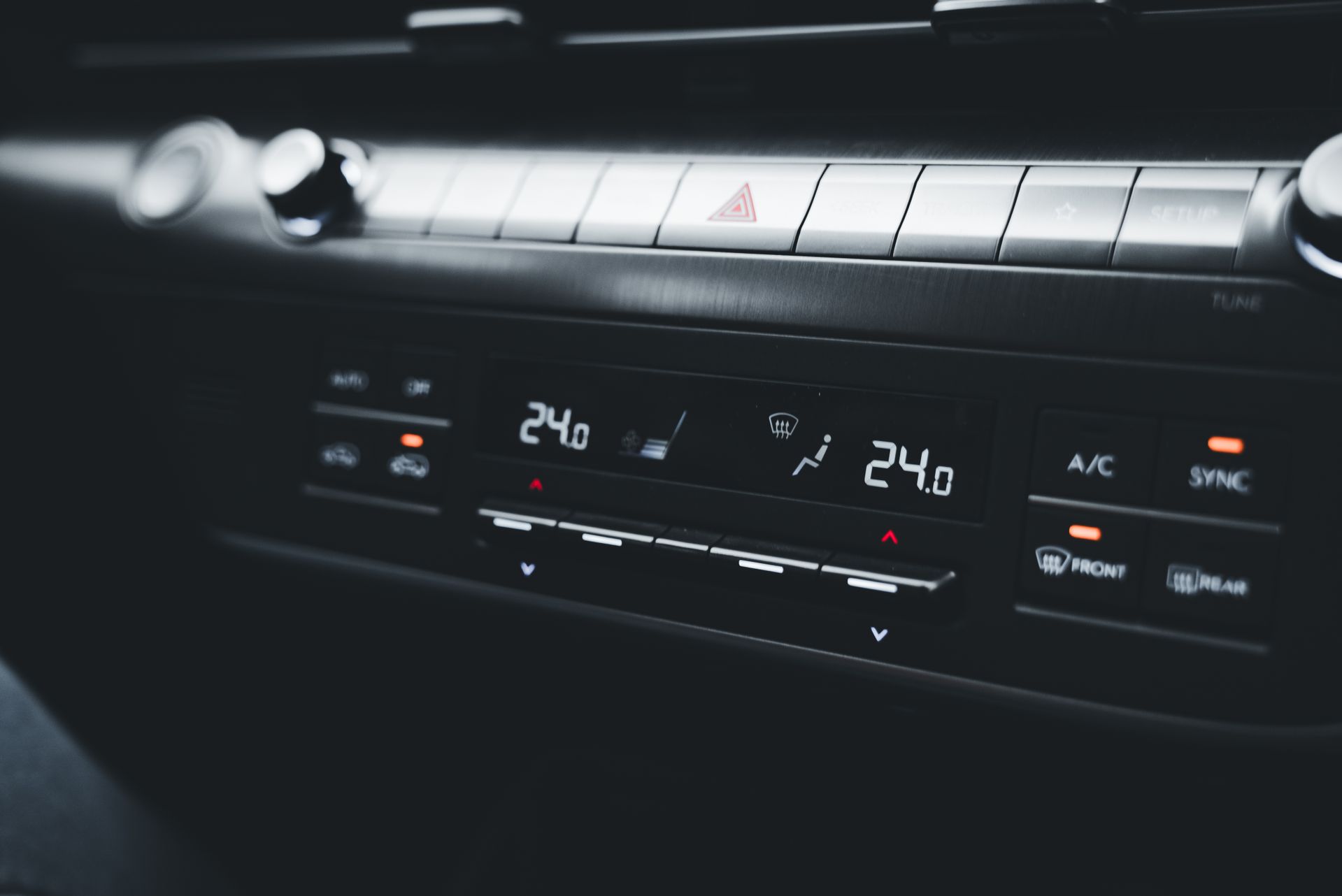 Car dashboard showing dual-zone climate control set to 24 degrees Celsius on both sides.