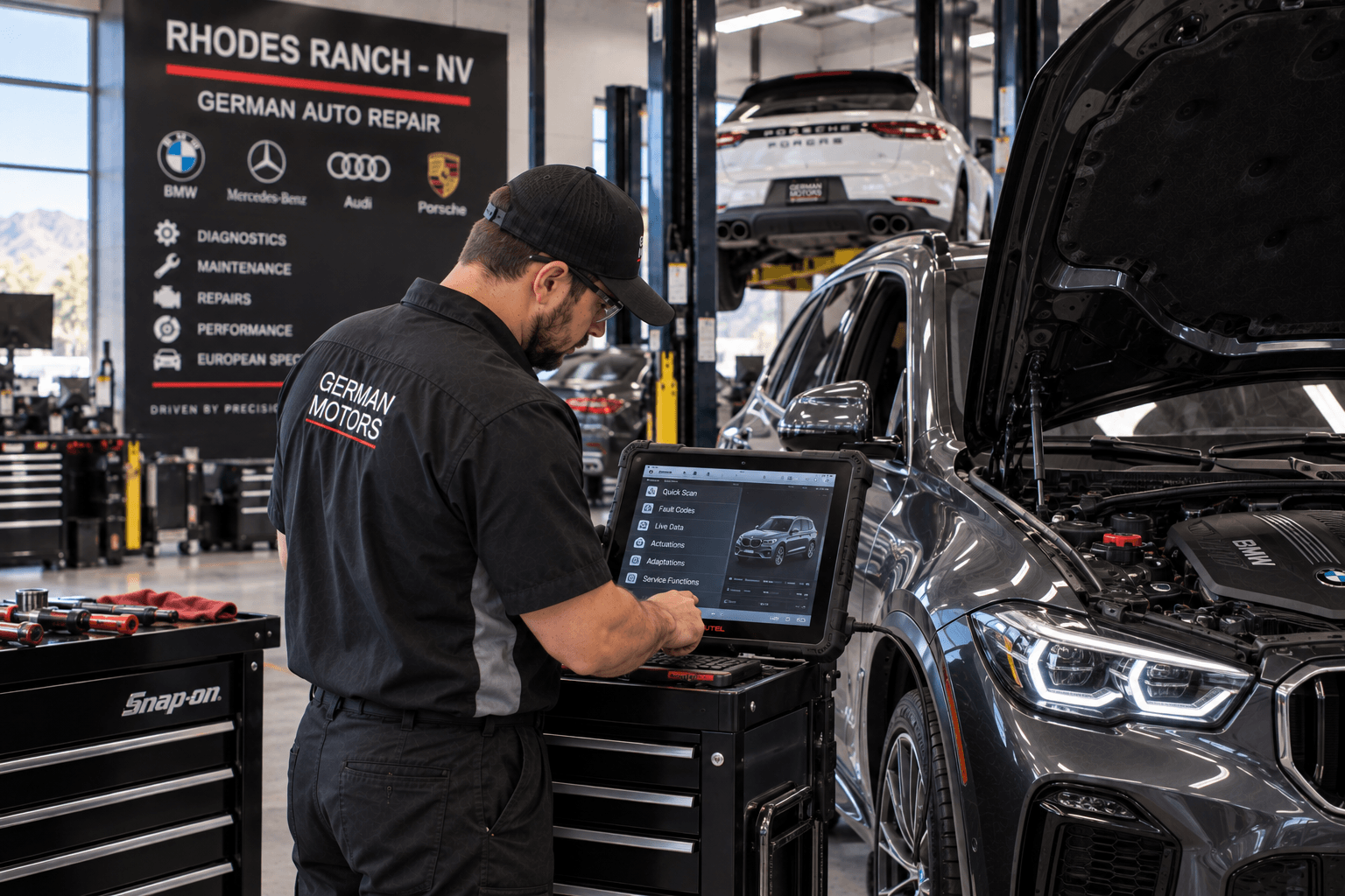 Specialist performing German Auto Repair with diagnostic tools beside a Rhodes Ranch - NV luxury crossover
