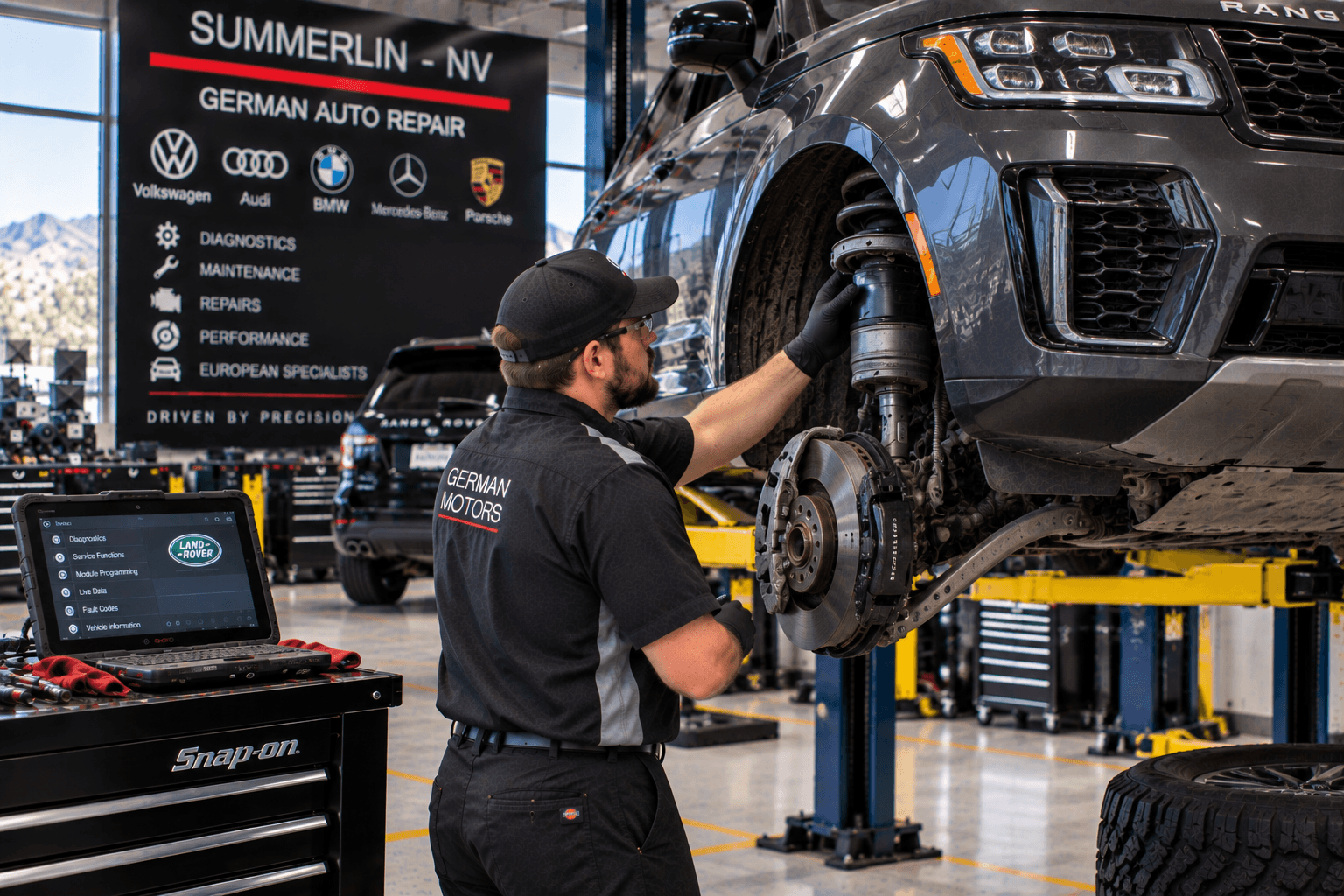 Land Rover Repair in Summerlin - NV technician inspecting suspension components on a lifted SUV