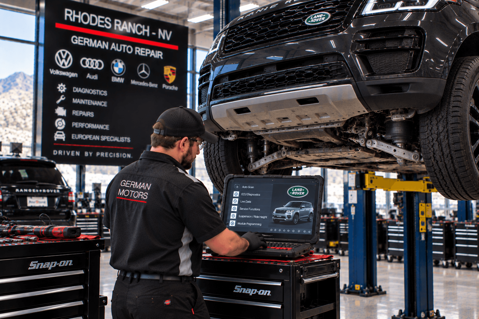 Land Rover Repair in Rhodes Ranch - NV technician diagnosing an SUV on a service lift
