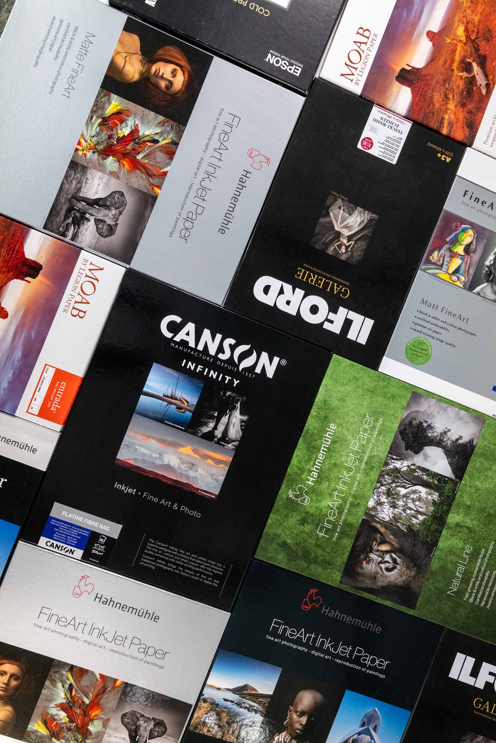 Archival fine art inkjet paper sample boxes arranged in a grid