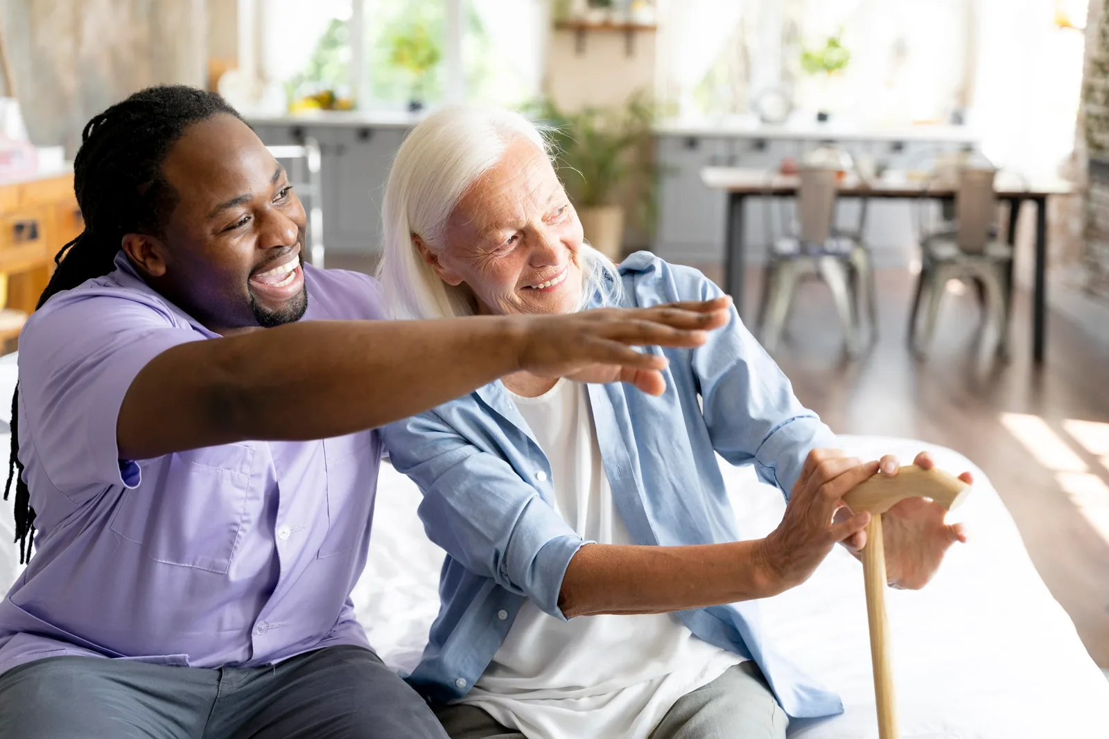 A social worker caring for a senior woman at home