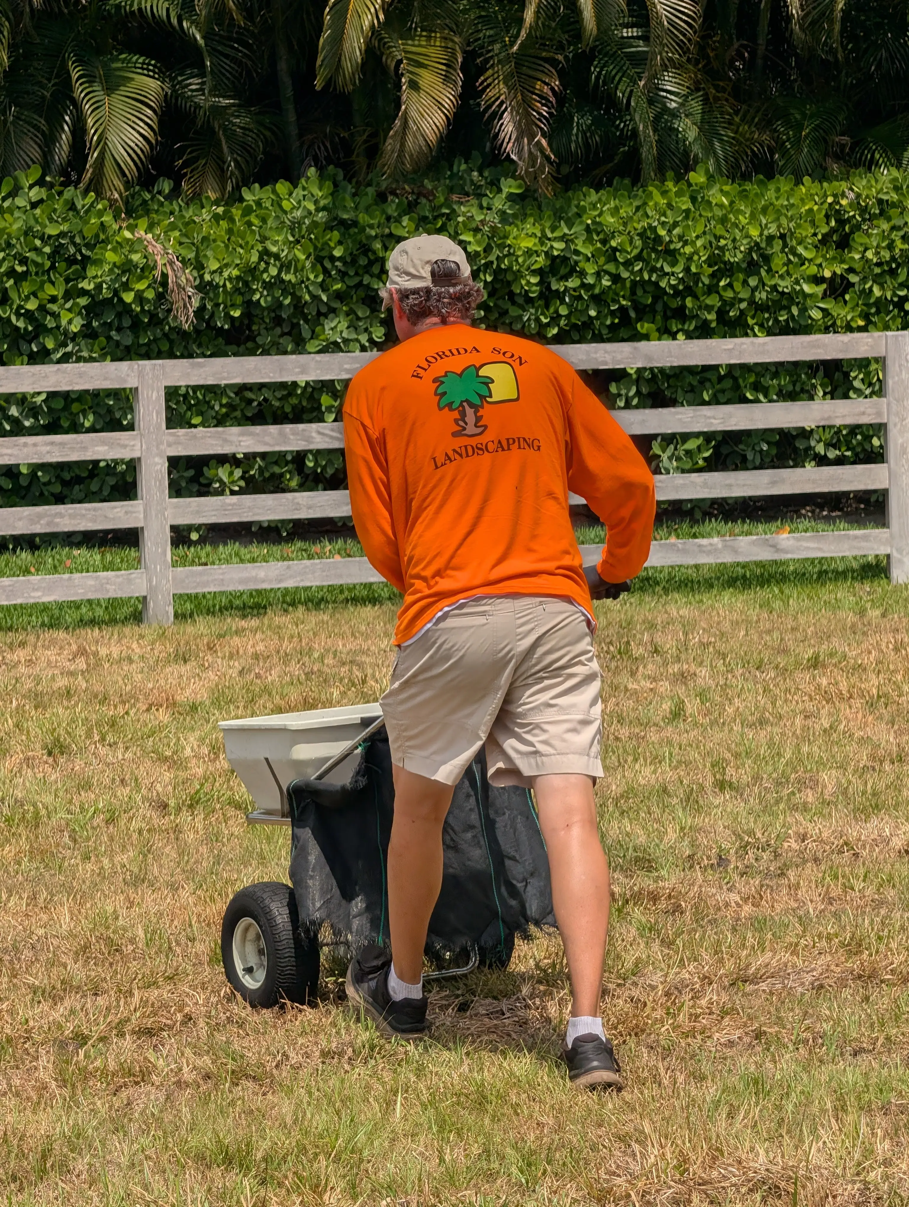 Florida Son Landscaping crew member maintaining a South Florida estate property