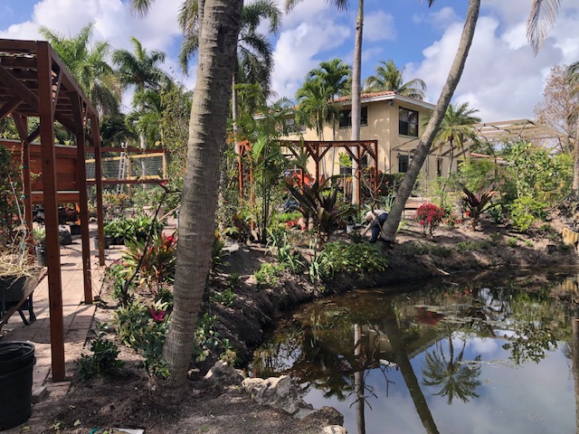 Florida Son Landscaping crew member maintaining a South Florida estate property