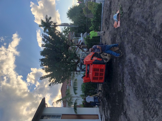 Florida Son Landscaping crew member maintaining a South Florida estate property