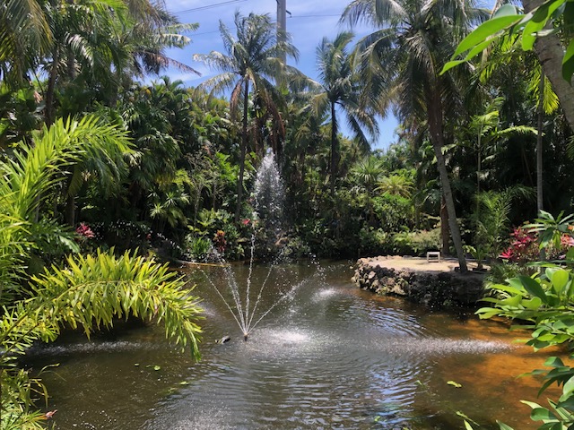 Florida Son Landscaping crew member maintaining a South Florida estate property