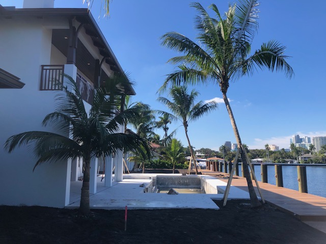 Florida Son Landscaping crew member maintaining a South Florida estate property