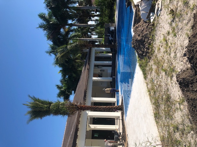 Florida Son Landscaping crew member maintaining a South Florida estate property