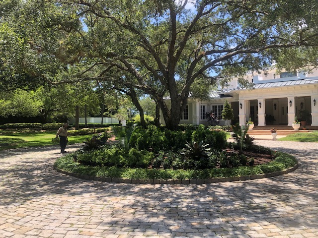 Florida Son Landscaping crew maintaining a South Florida estate lawn