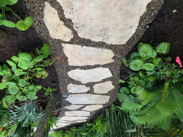 Florida Son Landscaping crew member maintaining a South Florida estate property
