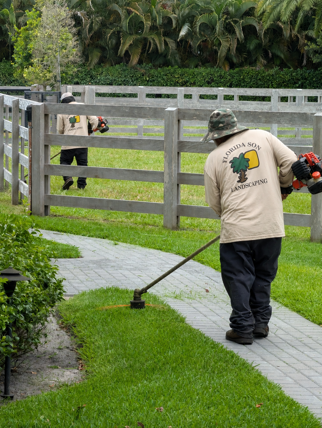 Florida Son Landscaping crew member maintaining a South Florida estate property