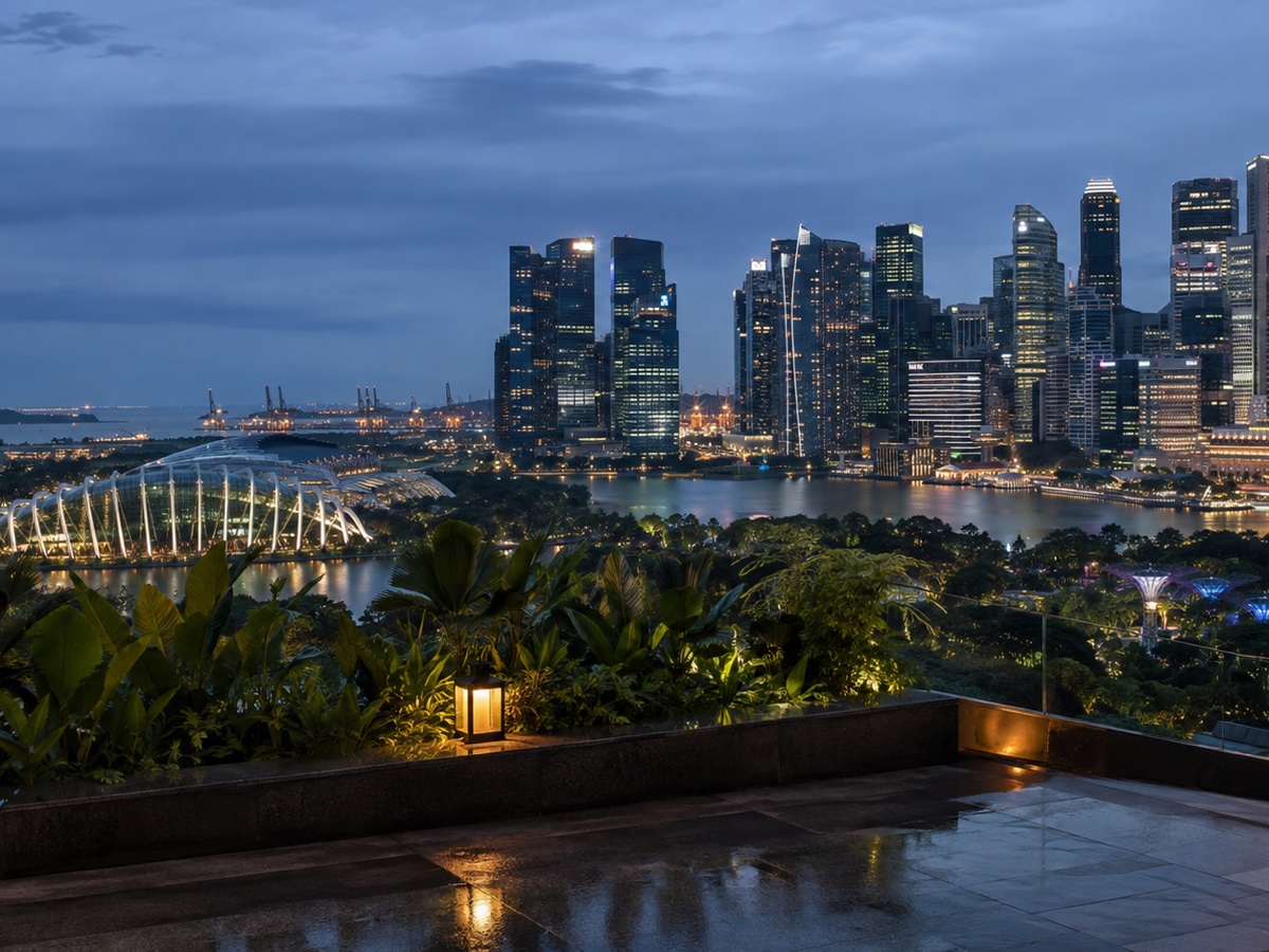Singapore's Marina Bay skyline beyond a tropical rooftop terrace at blue hour