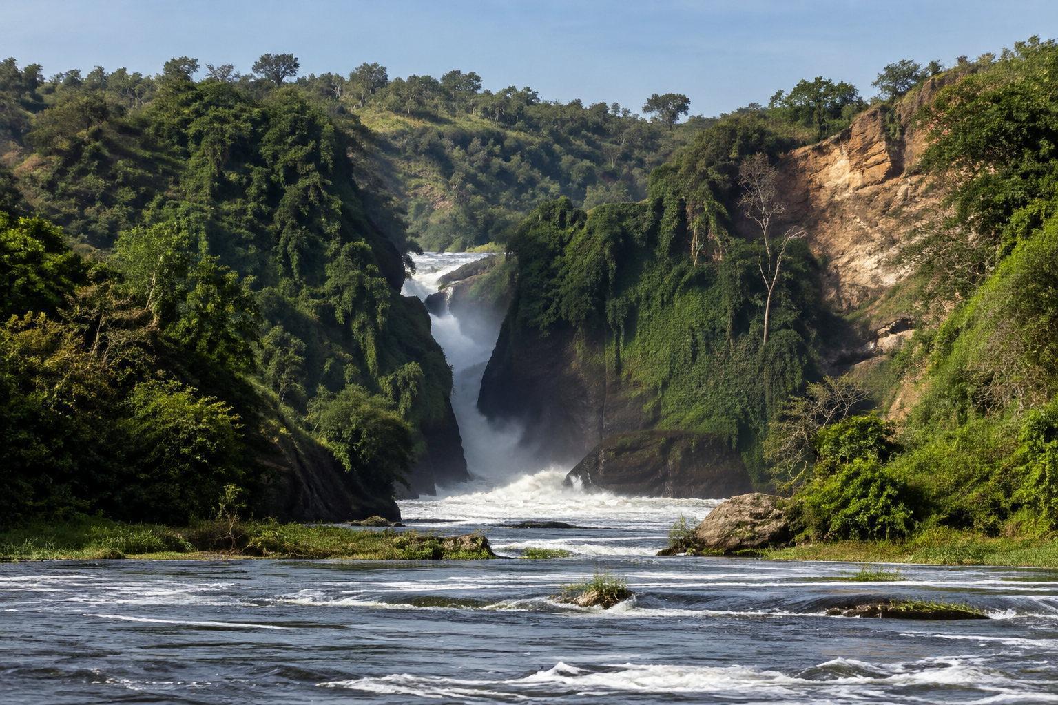 The Nile forcing through a narrow gorge into a wide green river valley in Uganda