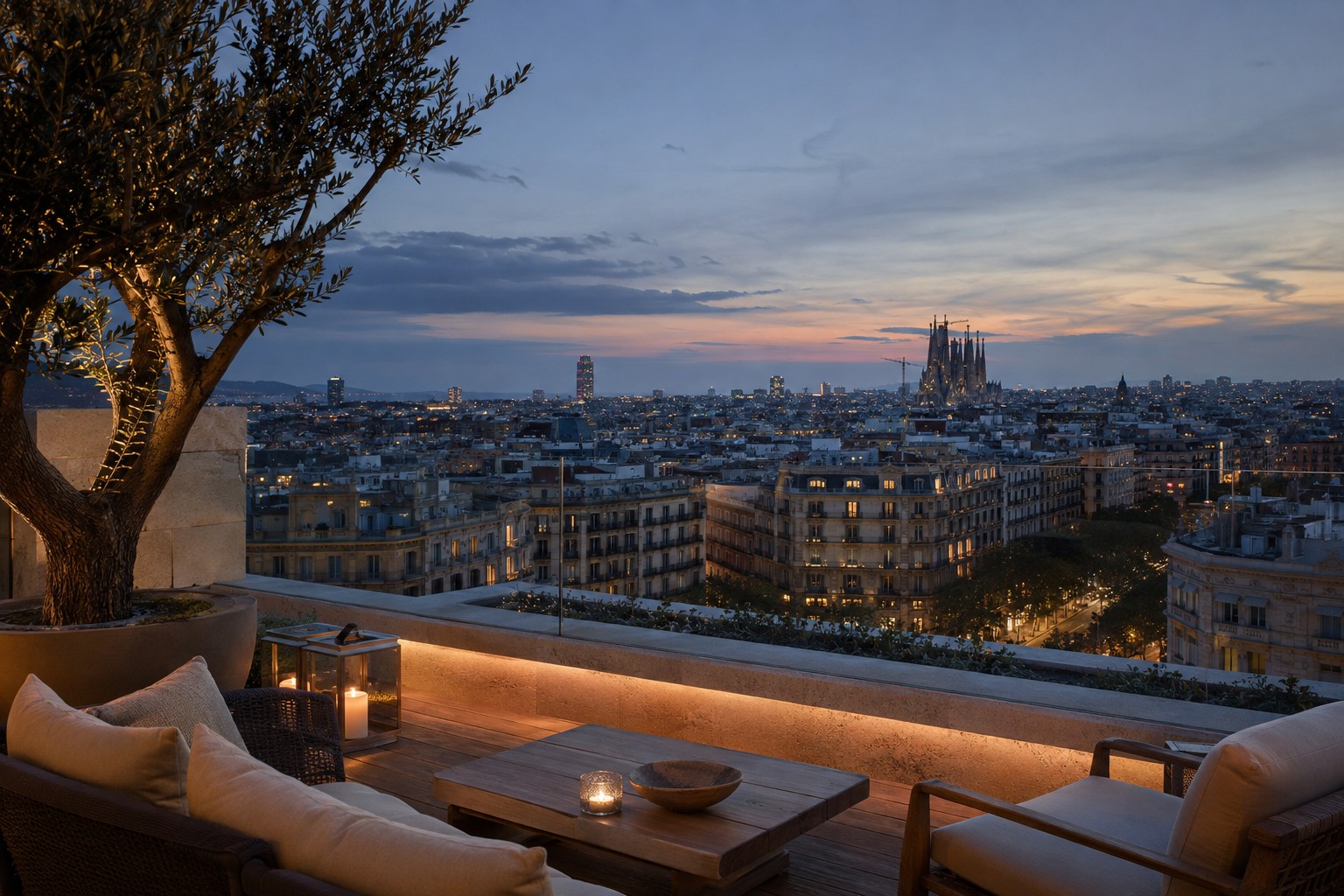Eixample rooftops at dusk showing the chamfered block grid with the Sagrada Familia spires beyond