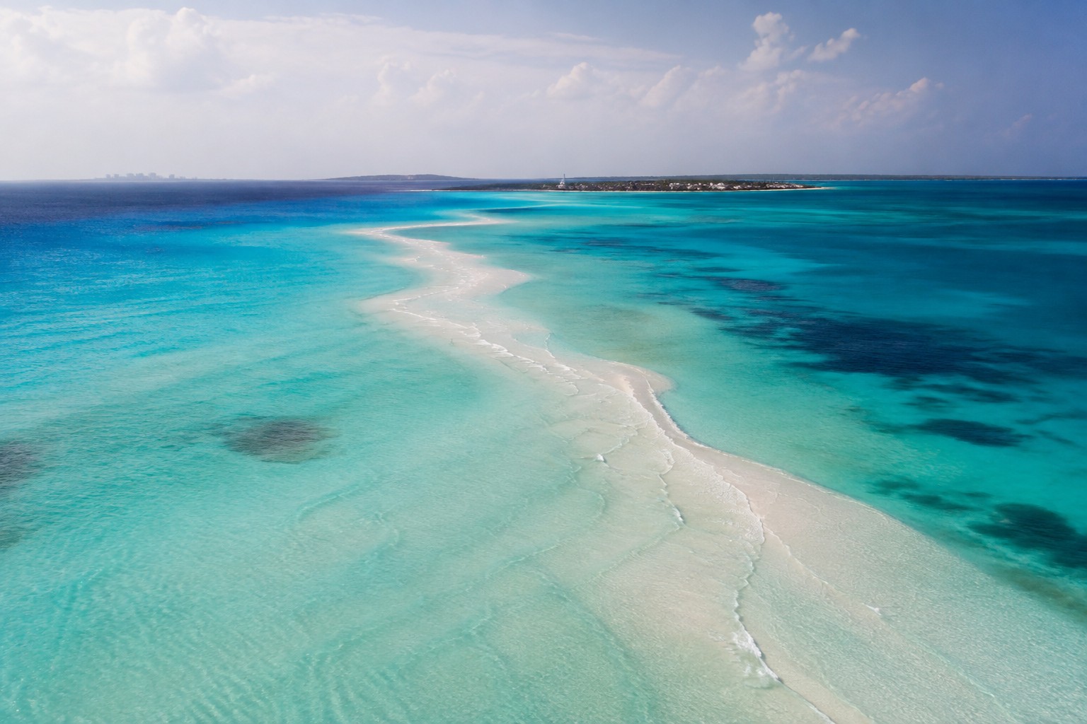 Aerial view of the sandbar and shallows off Isla Mujeres shading from turquoise to deep blue