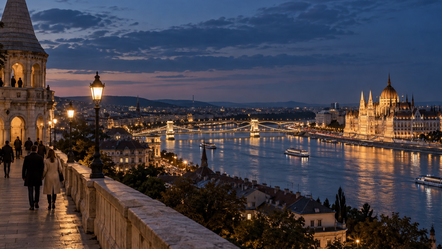 Budapest skyline and Parliament glowing across the Danube at blue hour